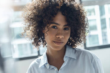 Young woman with curly hair at home - JSRF02327