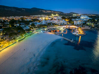 Spanien, Balearische Inseln, Santa Ponsa, Mallorca, Luftaufnahme der beleuchteten Küstenstadt in der Abenddämmerung - AMF09757