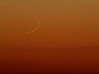 View of crescent moon rising against reddish sky at dusk - THGF00100