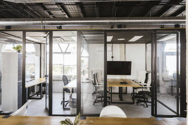 Empty coworking office with conference tables and chairs - LJF02446