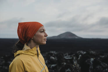 Thoughtful woman wearing bandana at Caldera Blanca volcano, Lanzarote, Canary Islands, Spain - DMGF00946