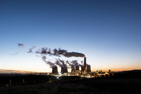 UK, England, Nottingham, Wasserdampf steigt aus Kühltürmen eines Kohlekraftwerks in der Abenddämmerung auf - WPEF06858