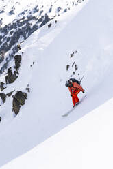 Man skiing downhill on Pyrenees mountain, Catalonia, Spain - JAQF01126