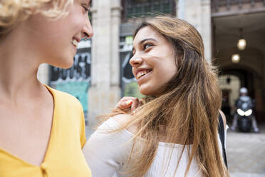 Smiling young woman spending leisure time with friend - WPEF06862