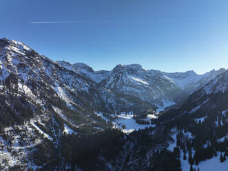 Snowy mountains in front of blue sky on sunny day - AMF09789