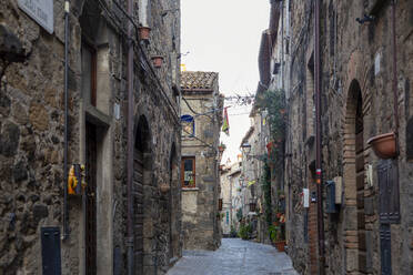 Italy, Lazio, Bolsena, Alley stretching between old stone houses - MAMF02386