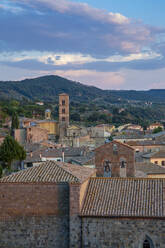 Italy, Lazio, Bolsena,Italy, Lazio, Bolsena, Old town houses with bell tower and forested hill in background - MAMF02389