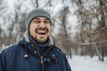 Happy man having fun in snow - ANAF00872