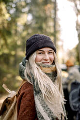 Portrait of smiling blond woman wearing knit hat - MASF34177