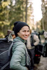 Side view of happy woman with backpack - MASF34180