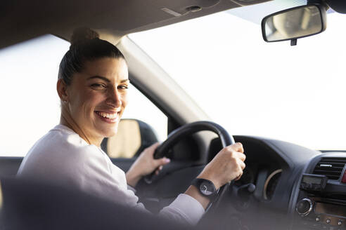 Happy young woman driving car - LJF02460