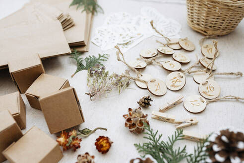 Various materials and cardboard boxes for Christmas advent calendar on carpet - SSYF00022