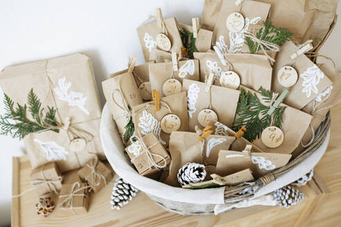 Decorated paper bags prepared for advent calendar and kept in basket - SSYF00037