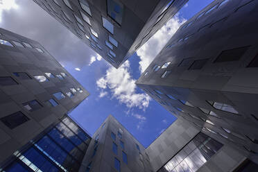 Netherlands, North Holland, Amsterdam, Directly below view of sky over gray modern buildings - FDF00366