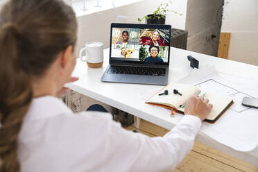 Businesswoman discussing on video conference in office - VPIF07835