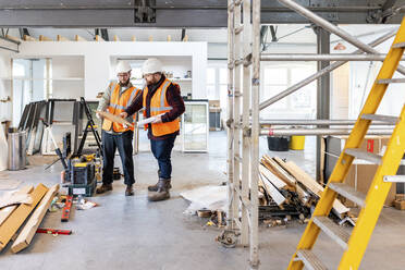 Engineers having discussion over document at construction site - WPEF06955