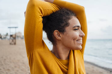 Happy young woman enjoying at beach - JOSEF15877