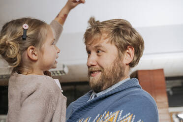 Girl playing with father at clubhouse - OSF01346