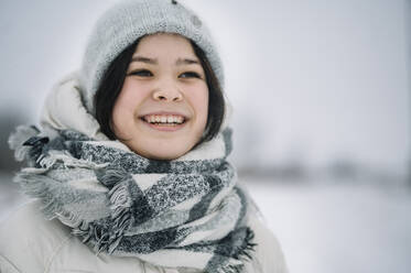 Happy girl wearing scarf and knit hat - ANAF00922