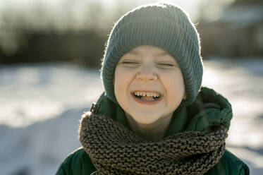 Cheerful boy wearing knit hat in winter - ANAF00924