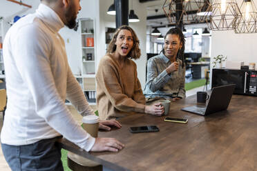 Geschäftsleute mit Kaffeetasse im Gespräch im Büro - WPEF06960