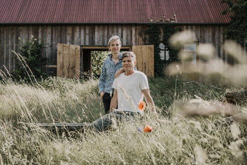 Owner couple in front of barn - MJRF00878