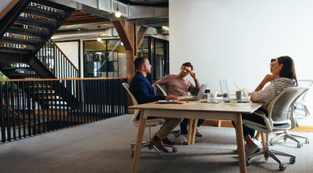 Business people having a meeting in an advertising agency. Group of marketing professionals having a discussion in a boardroom. Business team working on a project together. - JLPSF29259