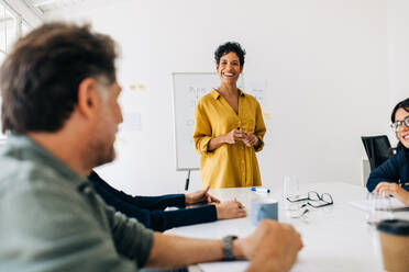 Business woman having a discussion with a team of professionals in an office. Black business woman leading a meeting in a boardroom. Female project manager doing a presentation. - JLPSF29282