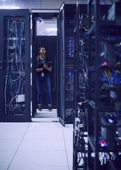 Female technician working in server room - TETF01882