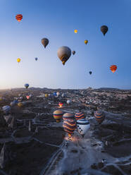 Aerial view of hot air balloons at sunrise in Cappadocia, Turkey. - AAEF17250