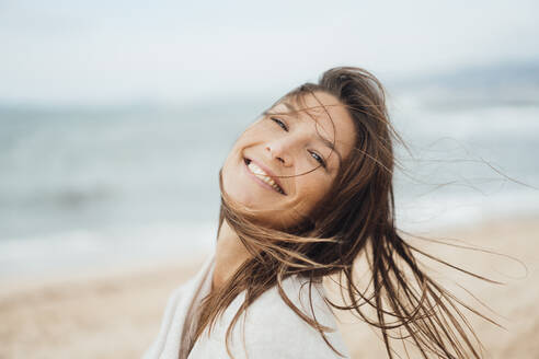 Happy woman with long hair enjoying at beach - JOSEF16208