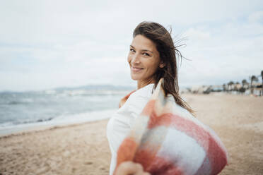 Carefree woman spending leisure time at beach - JOSEF16220