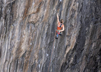 Sportlerin beim Klettern am Fels mit Klettergurt - ALRF01907