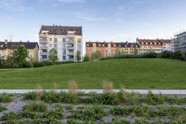 Deutschland, Bayern, München, Grünfläche vor neu errichteten Wohnhäusern - MAMF02550