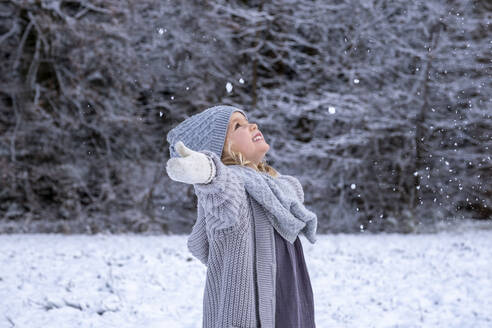 Smiling cute girl enjoying snow in winter - LBF03705