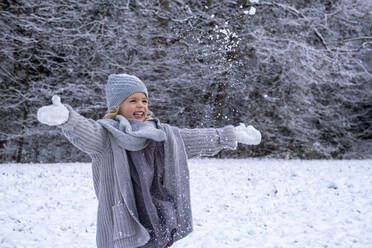 Cheerful girl in warm clothing enjoying snow - LBF03706