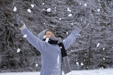 Happy boy in warm clothing enjoying snow - LBF03709