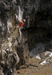 Mann beim Klettern an einem sonnigen Tag, Pembrokeshire, Wales - ALRF01959