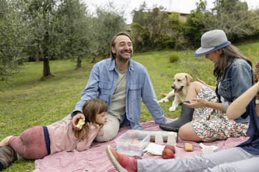 Happy family together having picnic on field - EIF04210