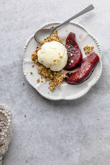 Plate of pears in red wine with ice cream and granola - FLMF00925