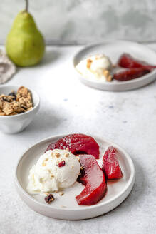 Pears in red wine with ice cream served on table - FLMF00926