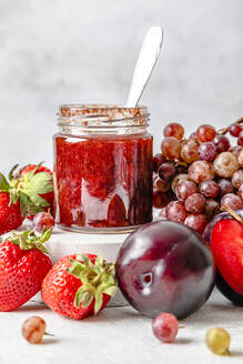 Homemade strawberry jam with various fruits kept on table - FLMF00931