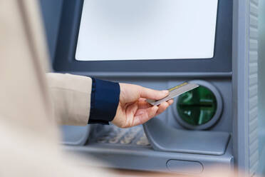 Hand of businesswoman with credit card at ATM - DIGF19751