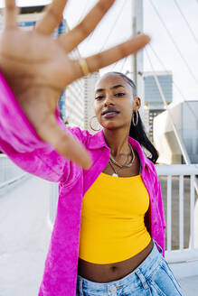 Young hip hop dancer gesturing on footbridge - OIPF03127