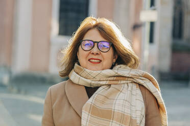 Glückliche ältere Frau mit Schal und Brille - VSNF00391