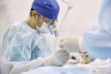 Doctors performing eye surgery on patient at hospital - SANF00013