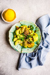 From above sliced of grilled zucchini vegetable in the bowl with sesame seed - ADSF43008