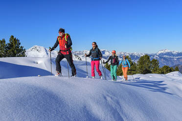 Austria, Tyrol, Group of skiers traveling in row across Grosser Galtenberg - ANSF00225