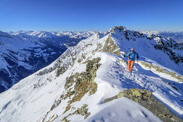 Austria, Tyrol, Female hiker on summit of Innerer Falk mountain - ANSF00233