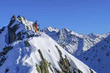 Austria, Tyrol, Female hiker on summit of Innerer Falk mountain - ANSF00235